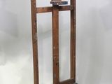 a wooden easel with a piece of wood sticking out of it