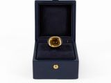 a close up of a ring in a box on a white background