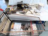 a shopping cart with many items in it on the floor
