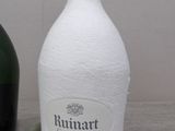 a bottle of wine next to a bottle of champagne