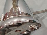 a silver faucet with a metal handle on a white surface