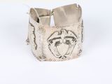 a close up of a silver bracelet with a horse on it