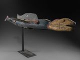 un gros plan d'une sculpture représentant un poisson posée sur un socle