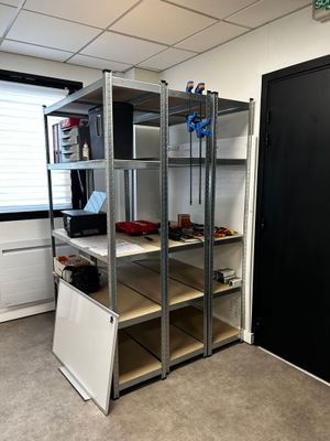 a room that has a bunch of shelves in it