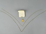 a necklace with a coin on it and a necklace with a chain attached to it
