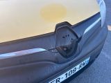 a close up of a car ' s front bumper with a plugged in