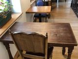 a table and chairs in a room with wood floors