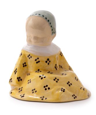 a figurine of a woman sitting on the ground