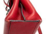 the inside of a red handbag with a zipper on it