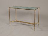 a gold and blue glass console table with brass legs