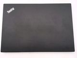 the back of a black laptop computer sitting on top of a white table