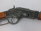 a gun with a wooden handle on a white surface