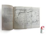 an open book with a map on it on a white surface