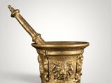 a gold mortar and pestula on a white background