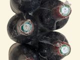 bottles of wine are stacked on top of each other on a table