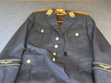 an image of a military uniform is displayed on a bed