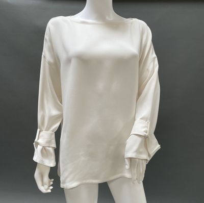 an image of a mannequin wearing a white dress with ruffled sleeves