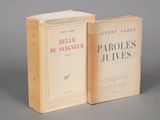 two books sitting on top of each other on a gray surface