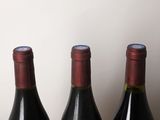 three bottles of wine sitting on a table next to each other