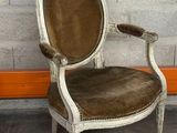 a chair that is sitting in front of a brick wall