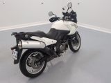 a white and black motorcycle parked in a room