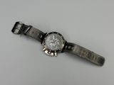 an image of a close up of a wrist watch on a table