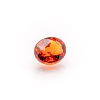 a close up of an orange sapphire stone on a white background