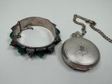 a silver locke with a chain around it and a silver locke with a chain around it on a white surface