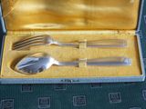a silverware set in a box with a fork and spoon