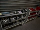 a metal shelf with many different tools in it