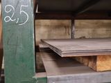 a stack of wooden planks on a shelf in a warehouse