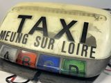 a close up of a taxi sign on top of a table