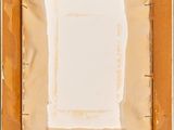 an overhead view of a piece of cardboard with a piece of paper in the middle of it