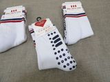 three pairs of white socks with red, white and blue stripes
