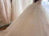 the back of a wedding dress is shown in a store