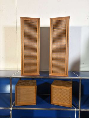 two wooden shutters on top of a blue shelf