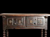 an old wooden table with two drawers on it