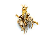 une image représentant une broche en forme d'oiseau en or et diamants