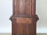 an old wooden cabinet with a door on top of it