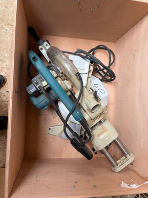 a box with a drill and other tools inside of it