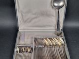 a case with silverware in it on a black surface
