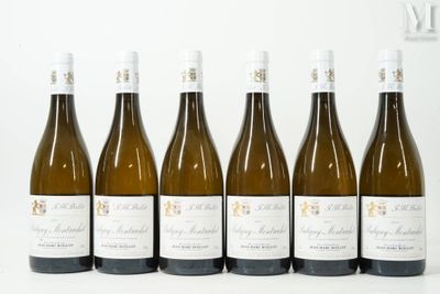 six bottles of wine are lined up in a row on a white surface