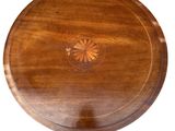 an image of a wooden table with a circular design on the top