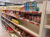 many shelves in the store with various foods on them