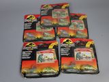 six toy dinosaurs are in a package on a table