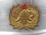 a metal helmet with a red star on top of it