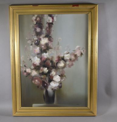 une photo d'un tableau de fleurs dans un cadre doré