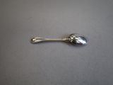 a silver spoon with a spoon handle on a table