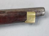 a very old gun that is laying on a table