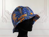 a close up of a mannequin head wearing a blue and orange hat